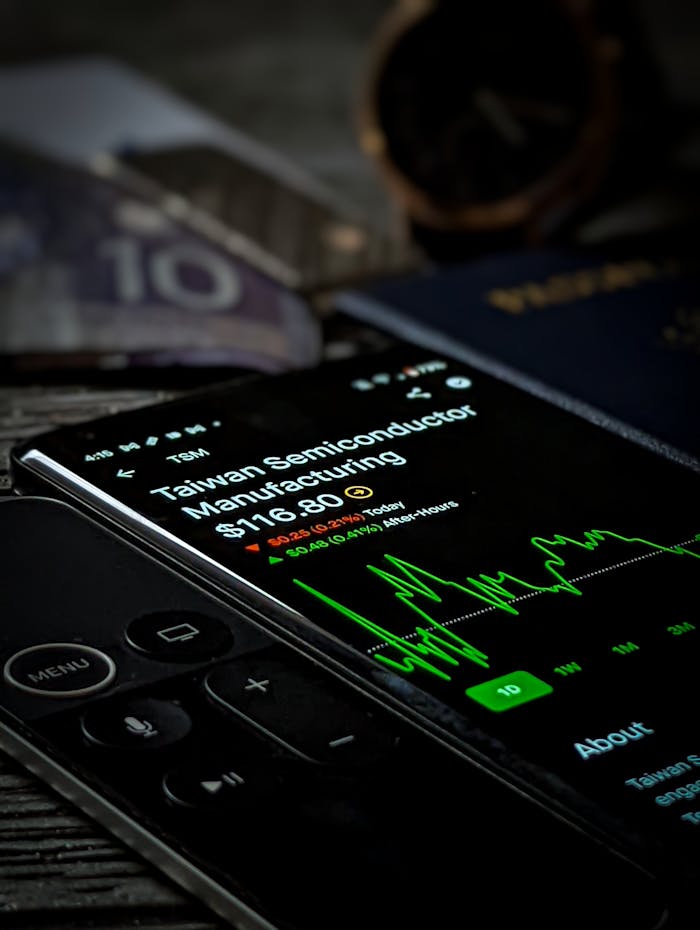 who-we-are Smartphone with stock market graph showing Taiwan Semiconductor Manufacturing data.